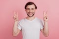 Portrait of friendly cheerful guy white smile show two v-signs on pink background