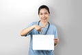 Portrait friendly Doctor woman holding pointing on blank paper sheet