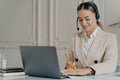 Positive young businesswoman in headset taking part in web conference Royalty Free Stock Photo