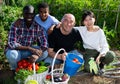 Portrait of friendly international family on farm field