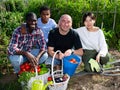 Portrait of friendly international family on farm field