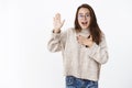 Portrait of friendly-looking relaxed charming carefree woman in glasses making swear or pledge, giving promise with hand Royalty Free Stock Photo