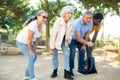 Portrait of mature couples playing petanque at leisure