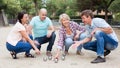 Friendly mature couples playing petanque at leisure