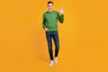 Portrait of friendly neighbor guy walk look camera wave hand on yellow background