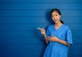 Portrait of friendly, smiling confident Asian woman doctor or nurse in blue suit. Royalty Free Stock Photo