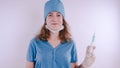 Portrait of a friendly smiling doctor woman or nurse in white medical uniform with a syringe, on white background with co Royalty Free Stock Photo