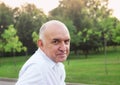 Portrait of friendly smiling senior man outdoors