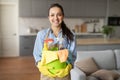 Confident woman holding bucket of cleaning supplies Royalty Free Stock Photo