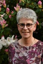 Portrait of a friendly woman standing in her garden Royalty Free Stock Photo