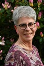 Portrait of a friendly woman standing in her garden Royalty Free Stock Photo