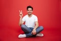 Portrait of a friendly young man in white t-shirt sitting Royalty Free Stock Photo