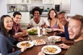 Portrait Of Friends Enjoying Dinner Party At Home