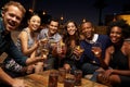 Portrait Of Friends Enjoying Night Out At Rooftop Bar Royalty Free Stock Photo