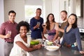 Portrait Of Friends Enjoying Pre Dinner Drinks At Home Royalty Free Stock Photo