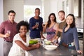 Portrait Of Friends Enjoying Pre Dinner Drinks At Home Royalty Free Stock Photo