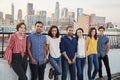 Portrait Of Friends Gathered On Rooftop Terrace For Party With City Skyline In Background Royalty Free Stock Photo