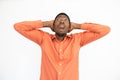 Portrait of frightened young man posing with hands behind head Royalty Free Stock Photo