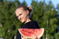 Portrait young girl refusing to eat watermelon on natural background