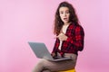 Portrait of frustrated computer user, teen girl pointing at laptop, looking worried about software error. pink background Royalty Free Stock Photo