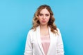 Portrait of frustrated displeased unhappy woman feeling insulted or offended, resentful face. blue background Royalty Free Stock Photo