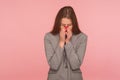 Portrait of frustrated sad young woman in business suit crying and covering face with hands, feeling lonely Royalty Free Stock Photo