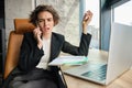 Portrait of frustrated saleswoman, businesswoman having an argument over the phone, difficult conversation over the Royalty Free Stock Photo