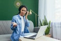Portrait of frustrated and upset woman at home, Hispanic woman working remotely looking at laptop at work and video call