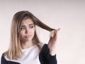 Portrait of a frustrated young brunette woman with a split hair Royalty Free Stock Photo