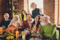 Portrait of full family eight people thanks giving party sit served dinner showing v-sign symbols photographing living