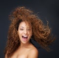 Portrait of a fun and happy young woman laughing with hair blowing Royalty Free Stock Photo