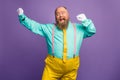 Portrait of funky crazy excited fat overweight man enjoy party discotheque dancing raise fists white gloves wear bright Royalty Free Stock Photo