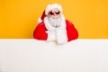 Portrait of funky funny santa claus put hands on white pure billboard advertise winter shopping season x-mas sales fairy