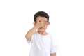 Portrait of funny Asian little boy child wearing glasses and closing hid eyes by one hand isolated over white background Royalty Free Stock Photo