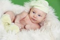 Portrait of funny baby boy resting on fur white bed Royalty Free Stock Photo