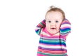 Portrait of a funny baby girl in a pink striped dress Royalty Free Stock Photo