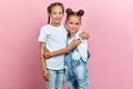 Portrait of a funny and beautiful adorable sisters hugging each other