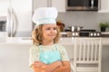 Portrait of funny child chef in kitchen. Chef kid boy baking on the kitchen. Child chef cook prepares food at kitchen Royalty Free Stock Photo