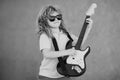 Portrait of a funny child with glasses practicing a song during a guitar lesson on street. Music concept, kids music Royalty Free Stock Photo