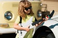 Portrait of a funny child with glasses practicing a song during a guitar lesson on street. Music concept, kids music Royalty Free Stock Photo