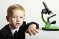 Portrait of funny child. little scientist with a microscope