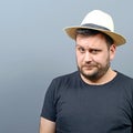 Portrait of funny chubby man wearing straw hat