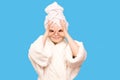 Portrait of funny comic playful child girl model with turban on head after shower making binoculars from hands having