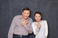 Portrait of funny couple pointing with thumbs at each other Royalty Free Stock Photo