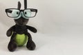 Portrait of funny cute plush firefly wearing eyeglasses isolated