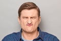 Portrait of funny disgruntled man making goofy crazy face Royalty Free Stock Photo