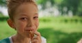 Portrait of funny eating boy on summer picnic. Child laugh on camera close up.