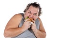 Portrait of funny fat man eating fast food burger isolated on white background