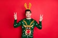 Portrait of funny funky brown hair man in reindeer mask show v-signs enjoy masquerade christmas time party wear deer Royalty Free Stock Photo