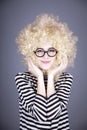 Portrait of funny girl in blonde wig. Royalty Free Stock Photo